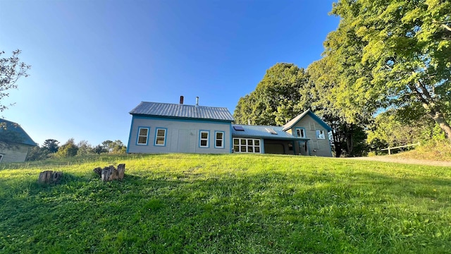 rear view of house with a yard