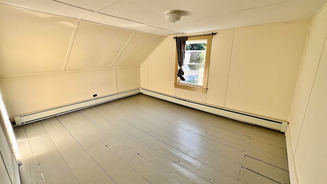 bonus room featuring a baseboard heating unit, hardwood / wood-style floors, and lofted ceiling