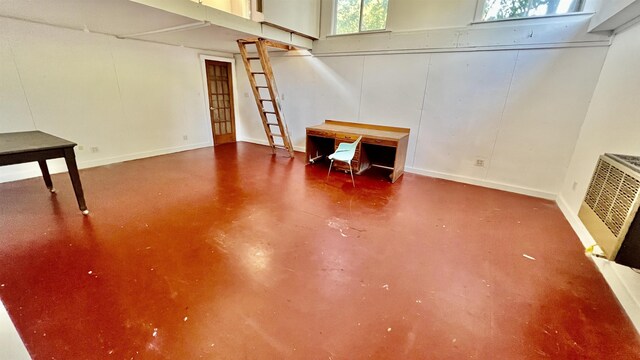 misc room featuring heating unit and concrete flooring