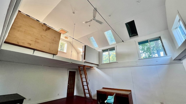 staircase with ceiling fan and a towering ceiling