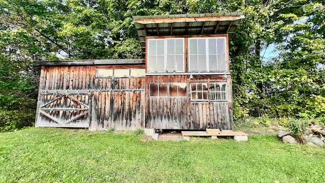 view of outbuilding featuring a lawn