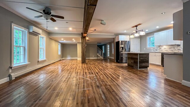 kitchen with a center island, dark hardwood / wood-style flooring, a baseboard radiator, and white cabinets