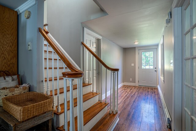 interior space with ornamental molding and hardwood / wood-style flooring