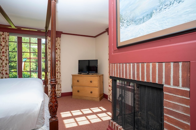 carpeted bedroom with baseboards, a brick fireplace, and ornamental molding