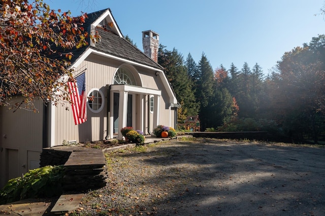 view of side of home featuring a chimney