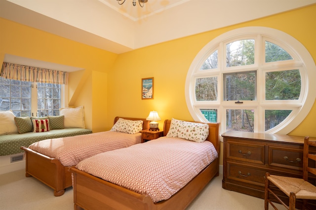 bedroom featuring visible vents and light carpet