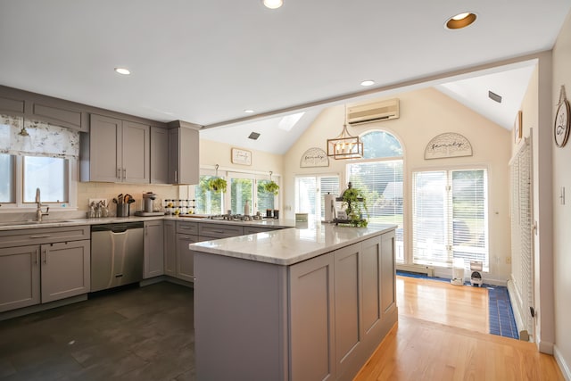 kitchen with a wall mounted air conditioner, sink, dark hardwood / wood-style floors, lofted ceiling, and stainless steel dishwasher