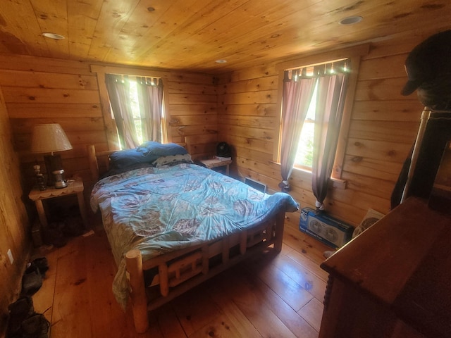 bedroom featuring wooden ceiling, wooden walls, and dark hardwood / wood-style floors