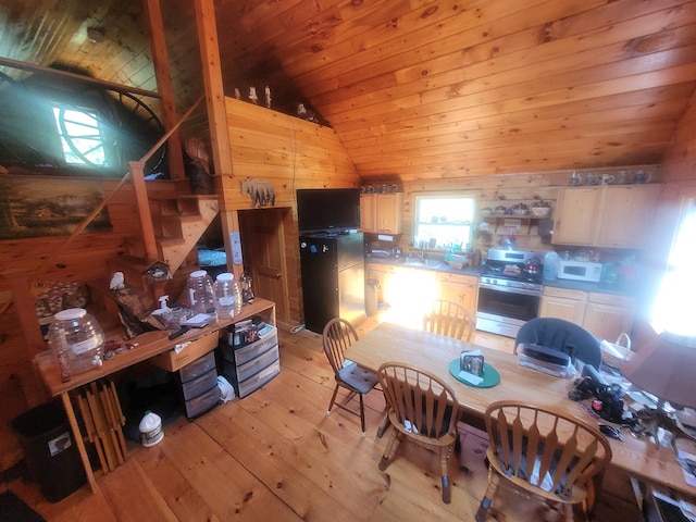 kitchen with light wood-type flooring, vaulted ceiling, light brown cabinets, gas range, and wooden ceiling