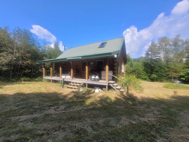 exterior space featuring a porch and a yard