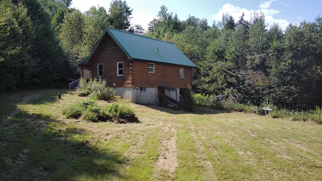 view of side of home with a lawn