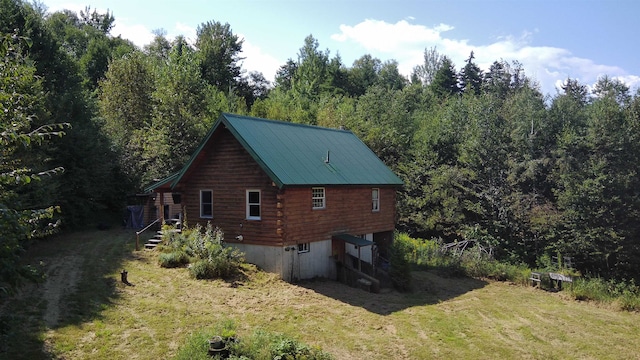 view of side of home with a yard