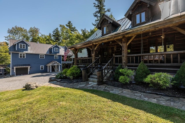 view of front facade with a porch, a front lawn, and a garage