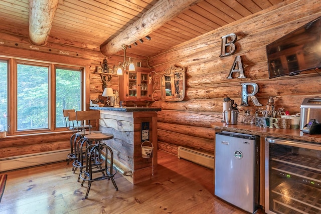 bar with beverage cooler, hardwood / wood-style flooring, stainless steel refrigerator, beamed ceiling, and pendant lighting