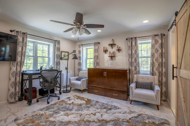 office with ceiling fan and a barn door