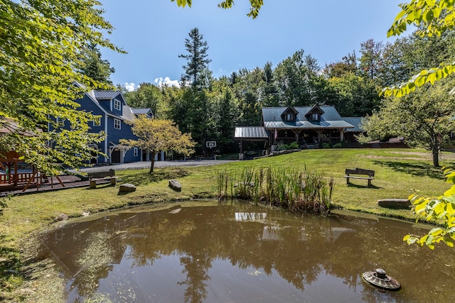 surrounding community featuring a water view and a lawn