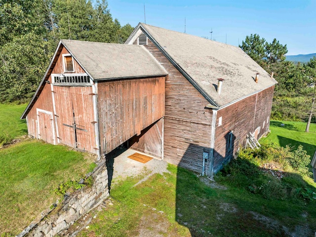 view of outbuilding featuring a lawn