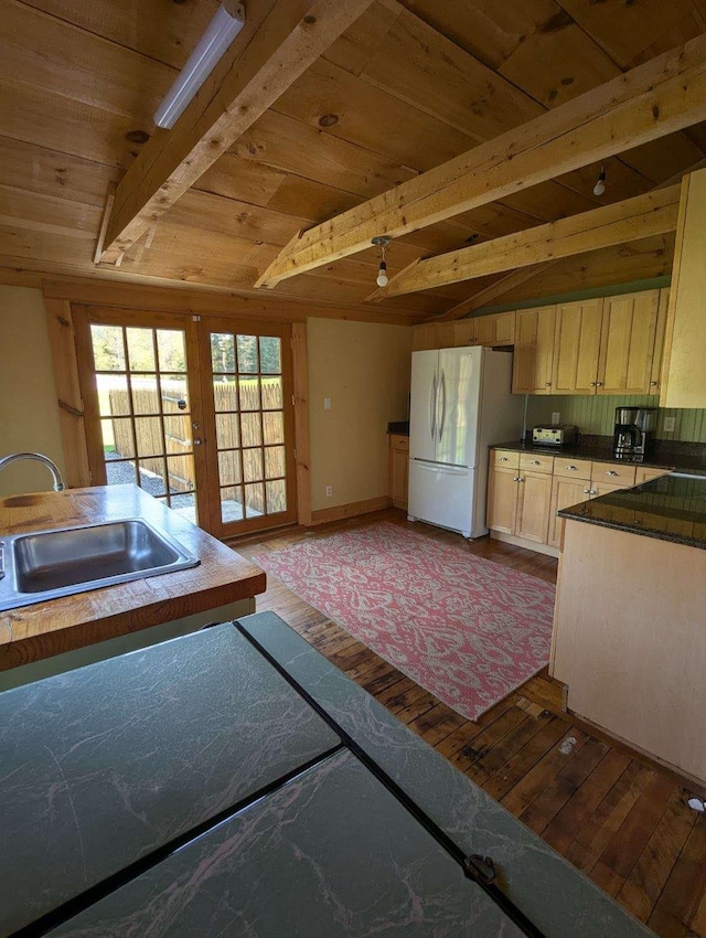 kitchen featuring hardwood / wood-style floors, sink, wooden ceiling, white refrigerator, and light brown cabinets