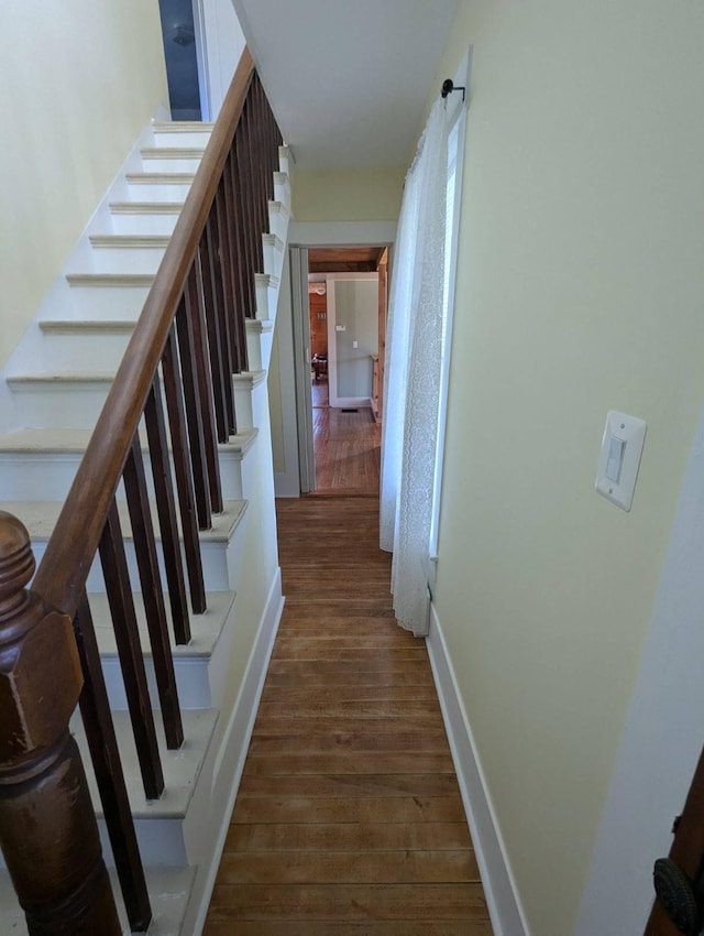 stairs featuring hardwood / wood-style floors