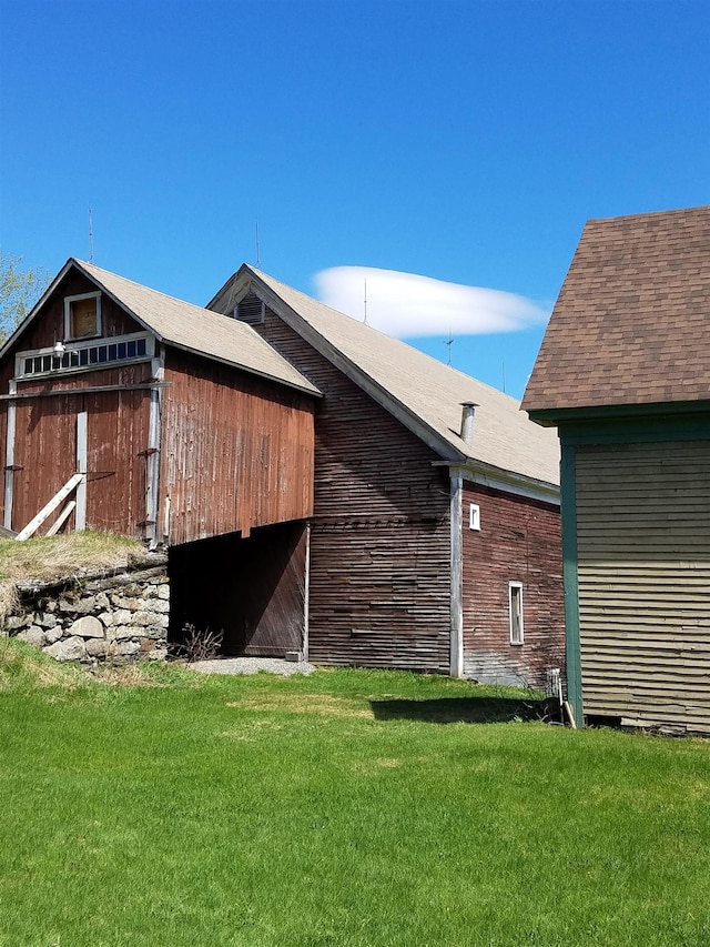 exterior space with an outbuilding and a lawn