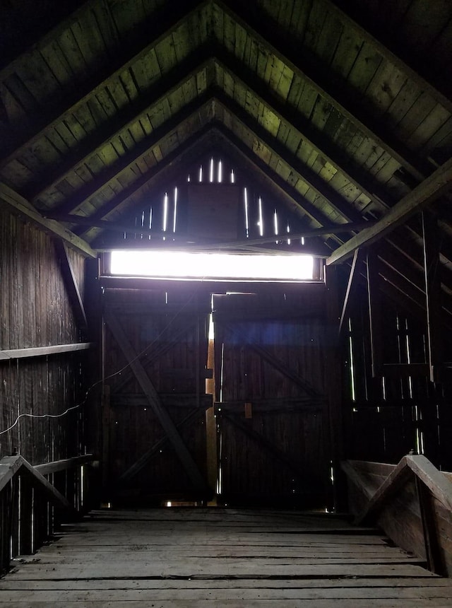 misc room with lofted ceiling, wood walls, wood ceiling, and hardwood / wood-style flooring