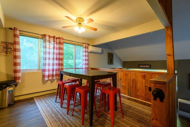 dining space featuring a baseboard radiator, lofted ceiling, a textured ceiling, a wall mounted AC, and dark wood-style flooring