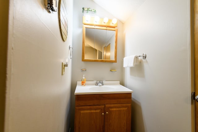 bathroom with vanity and vaulted ceiling