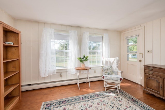 sitting room with a baseboard radiator and hardwood / wood-style flooring