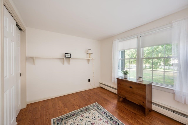 sitting room with hardwood / wood-style flooring and a baseboard radiator