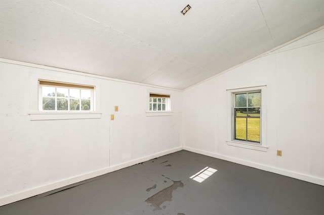 unfurnished room with vaulted ceiling