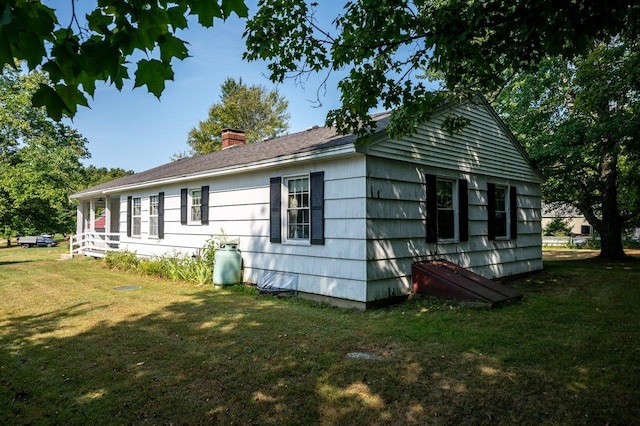 view of side of home featuring a yard