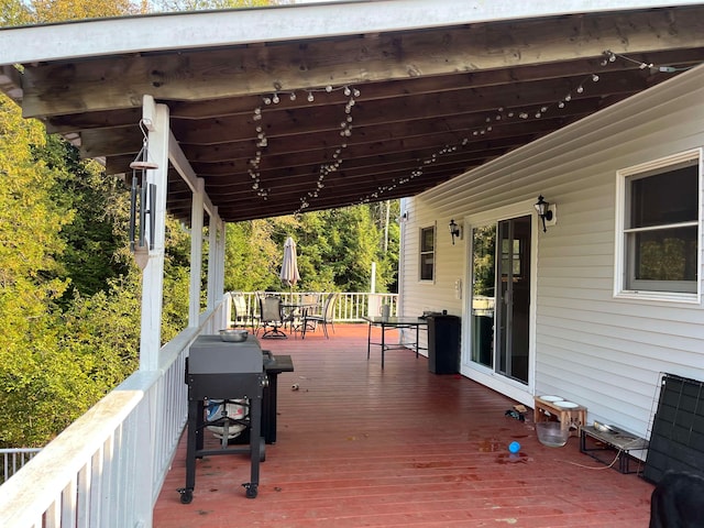 deck featuring a grill and outdoor dining space