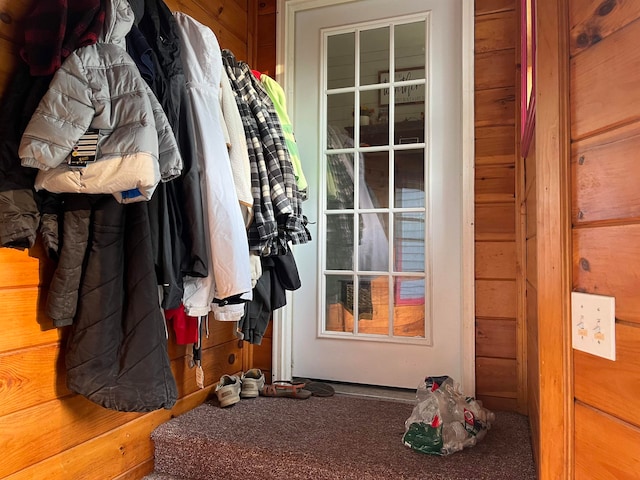 doorway with wood walls