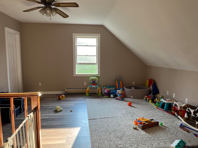 game room with a ceiling fan, vaulted ceiling, and wood finished floors