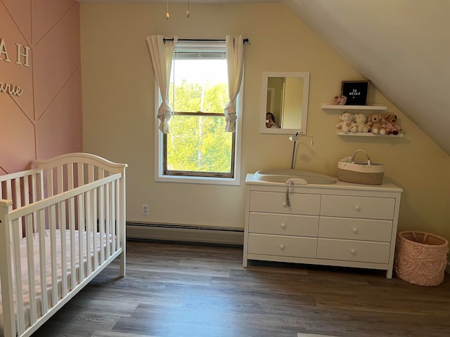 bedroom featuring lofted ceiling, a nursery area, a baseboard radiator, and dark wood-type flooring