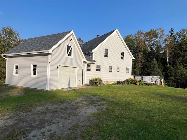 view of side of home with a garage, roof with shingles, a yard, and dirt driveway