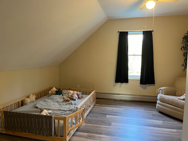 bedroom with vaulted ceiling, a baseboard radiator, wood finished floors, and a ceiling fan