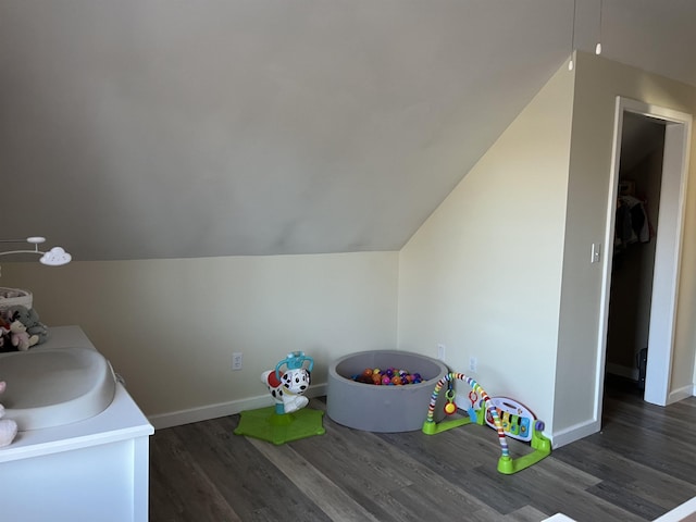 recreation room with baseboards, dark wood finished floors, and a sink