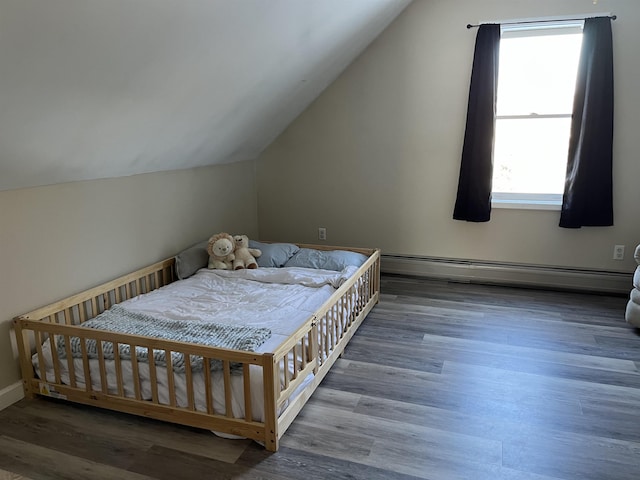 bedroom featuring vaulted ceiling, dark wood finished floors, and baseboard heating