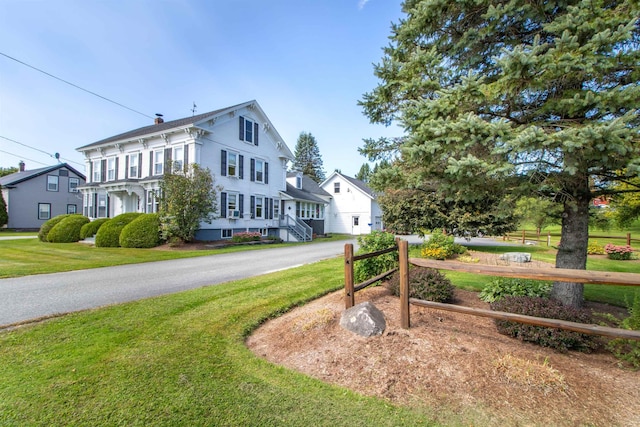 6694 Vt Route 100, Troy, VT 05859 - exterior space featuring a chimney, fence, and a front lawn