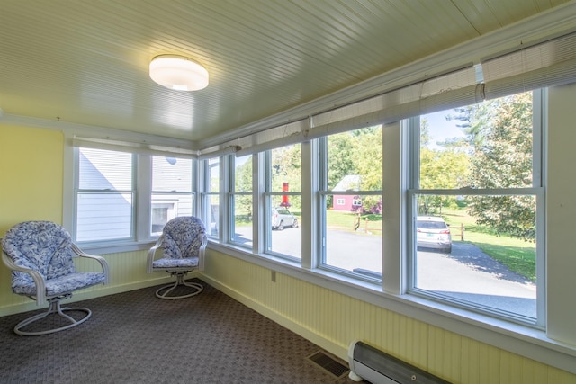 6694 Vt Route 100, Troy, VT 05859 - sunroom / solarium with carpet floors, visible vents, a baseboard heating unit, and a healthy amount of sunlight