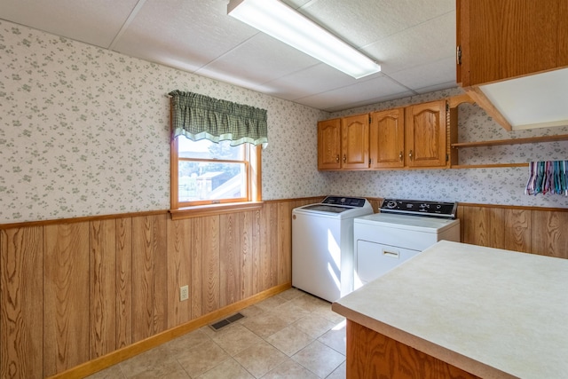 6694 Vt Route 100, Troy, VT 05859 - laundry room with wallpapered walls, a wainscoted wall, visible vents, cabinet space, and washer and dryer