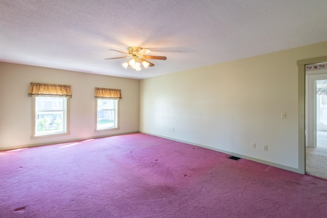 carpeted spare room with a textured ceiling and ceiling fan