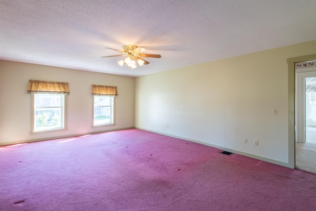 6694 Vt Route 100, Troy, VT 05859 - unfurnished room with baseboards, a textured ceiling, visible vents, ceiling fan, and carpet
