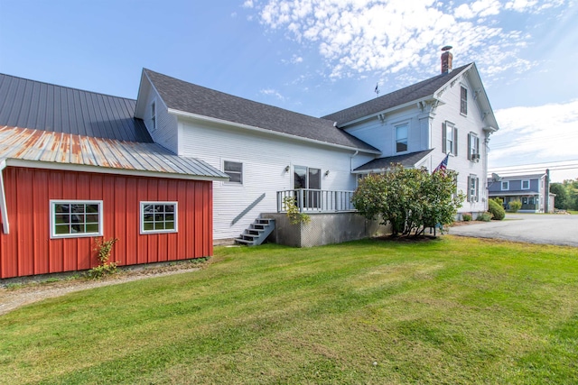 6694 Vt Route 100, Troy, VT 05859 - back of property with board and batten siding and a yard