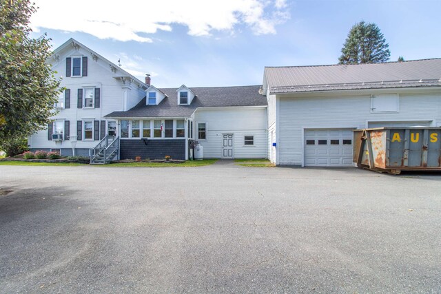 6694 Vt Route 100, Troy, VT 05859 - view of front of house with an attached garage and aphalt driveway