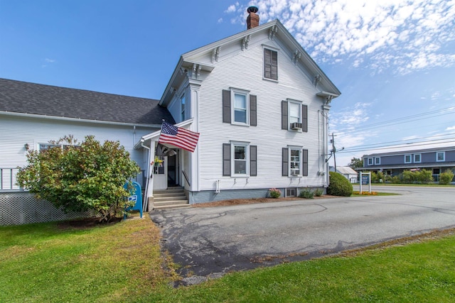 6694 Vt Route 100, Troy, VT 05859 - view of front of property featuring cooling unit, a chimney, and a front lawn
