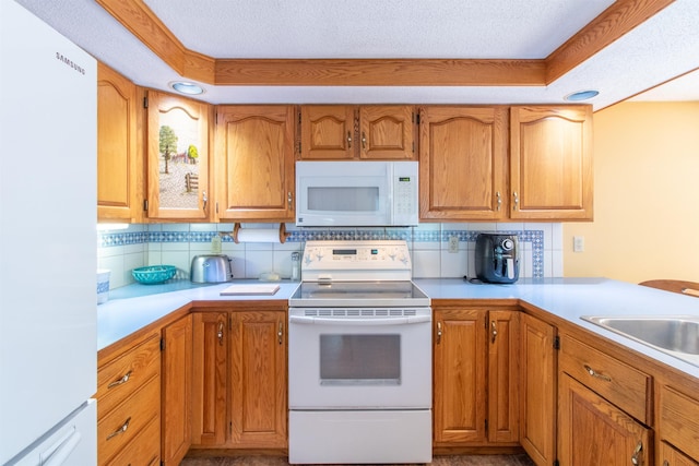 6694 Vt Route 100, Troy, VT 05859 - kitchen featuring tasteful backsplash, light countertops, and white appliances