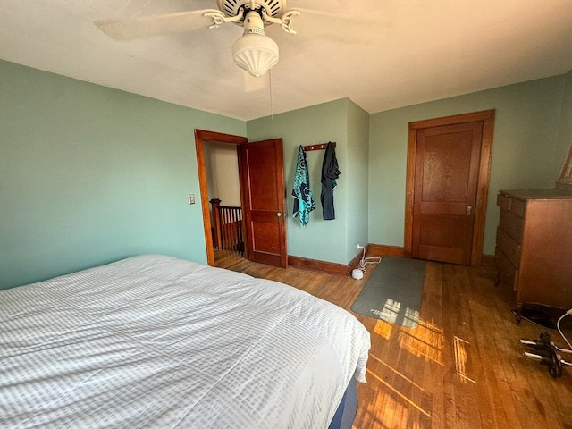 bedroom with hardwood / wood-style floors and ceiling fan