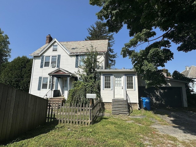 view of front of home featuring a garage and a front yard